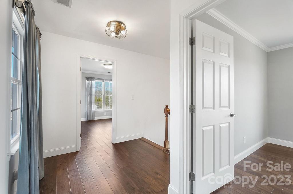 6715 Faith Road Salisbury, NC 28146 - Photo 32 of 48 a view of a hallway with wooden floor and a room
