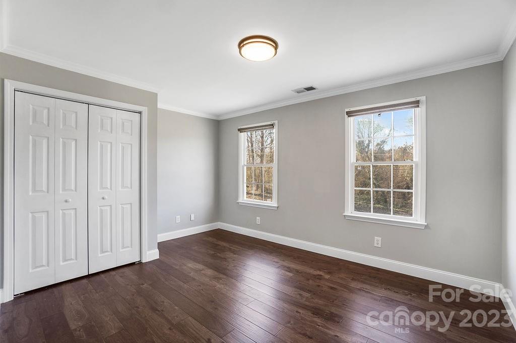 6715 Faith Road Salisbury, NC 28146 - Photo 43 of 48 an empty room with wooden floor and windows
