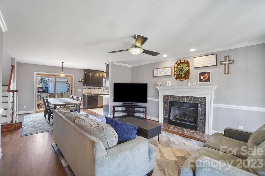 6715 Faith Road Salisbury, NC 28146 - Photo 10 of 48 a living room with furniture a flat screen tv and a fireplace