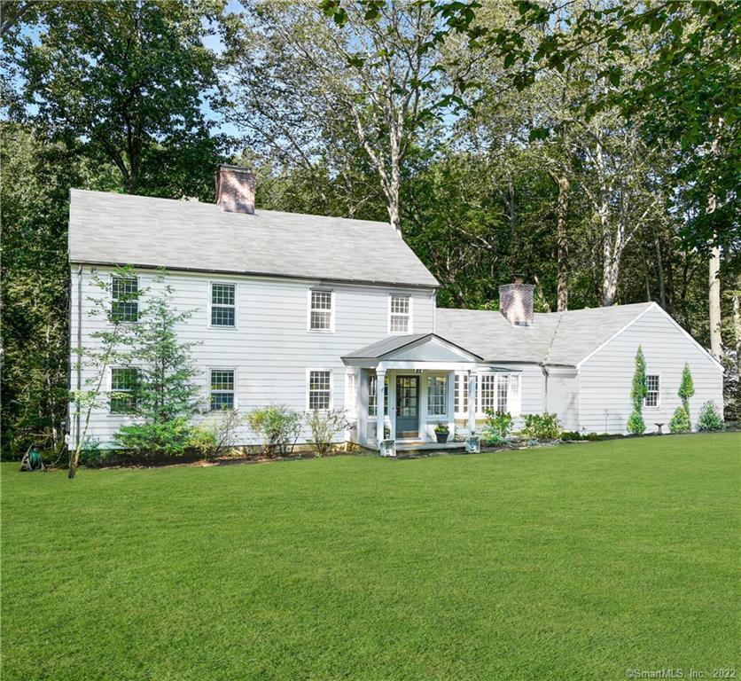 260 Whiting Pond Road Fairfield, CT 06824 - Photo 1 of 1 a front view of a house with a garden and trees