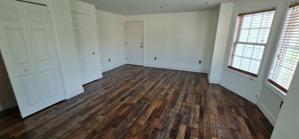 41 West Street, Unit 3 Boston, MA 02136 - Photo 11 of 23 a view of a room with wooden floor and window