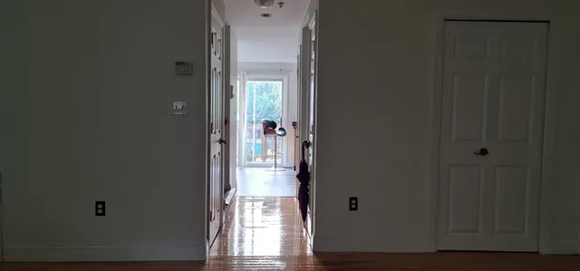 a view of an entryway with wooden floor