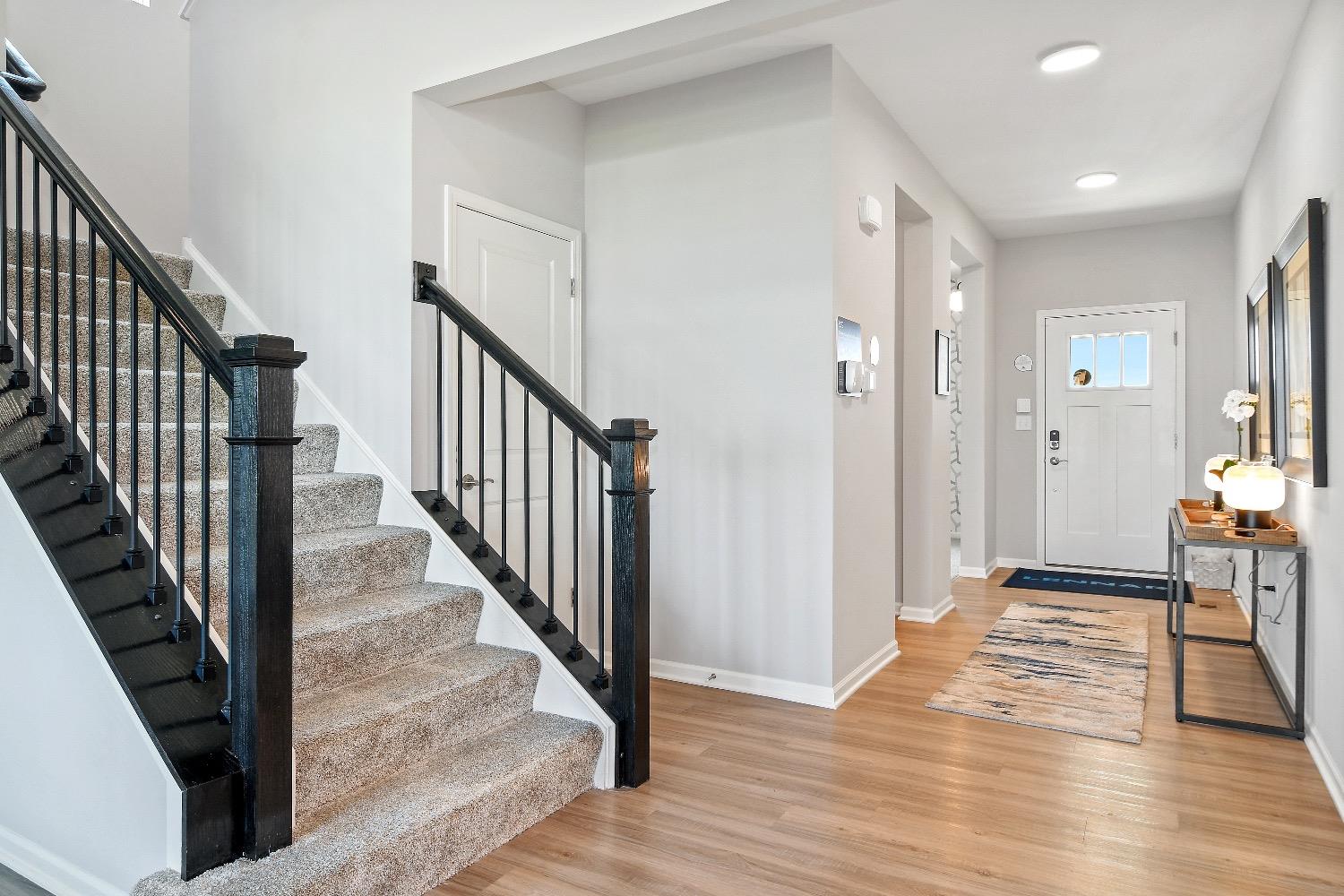 11566 Clyde Crown Point Merrillville, IN 46410 - Photo 4 of 27 a view of a hallway with wooden floor and staircase