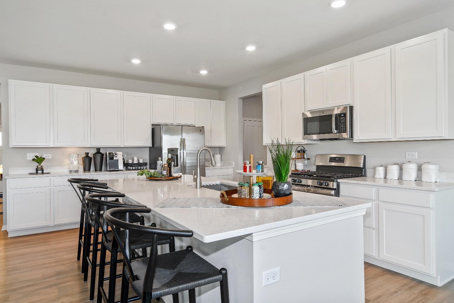 11566 Clyde Crown Point Merrillville, IN 46410 - Photo 5 of 27 a kitchen with a table chairs microwave and cabinets