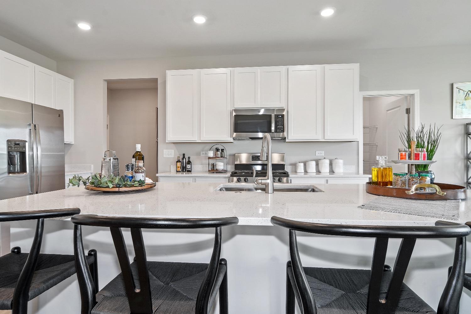 11566 Clyde Crown Point Merrillville, IN 46410 - Photo 6 of 27 a kitchen with stainless steel appliances granite countertop a table chairs microwave and cabinets