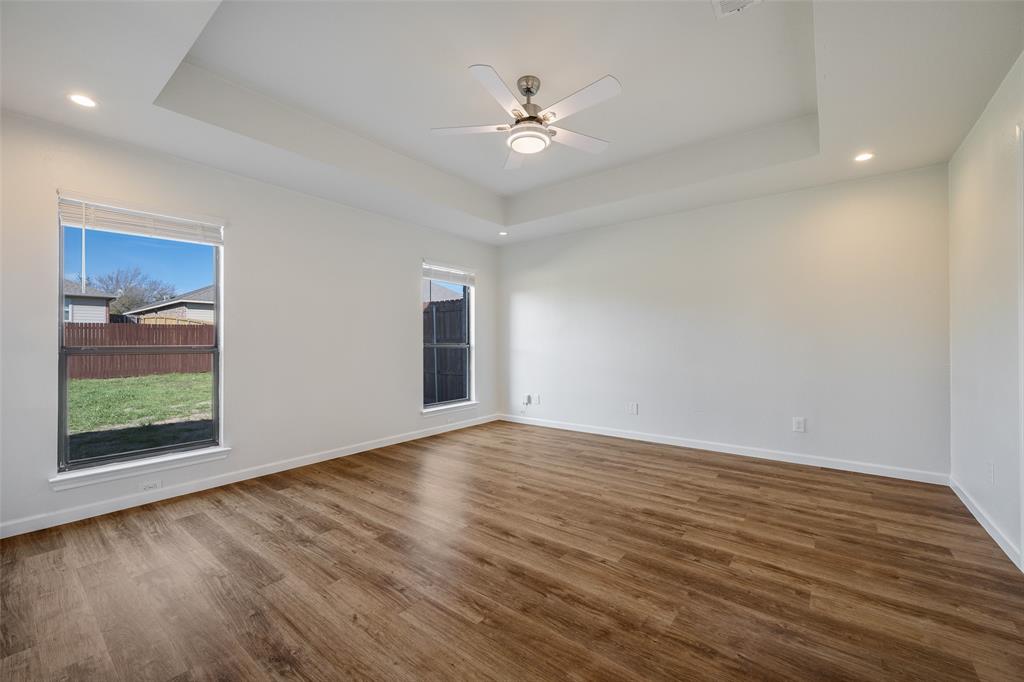 826 Hazel's Way Anna, TX 75409 - Photo 12 of 25 a view of an empty room with wooden floor and a window
