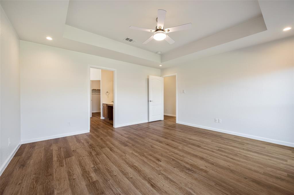 826 Hazel's Way Anna, TX 75409 - Photo 13 of 25 a view of an empty room with wooden floor