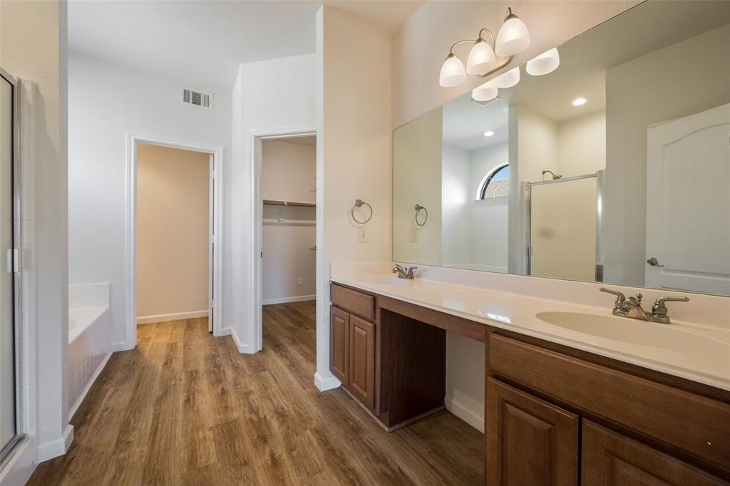 826 Hazel's Way Anna, TX 75409 - Photo 14 of 25 a spacious bathroom with a granite countertop sink a toilet a mirror and vanity