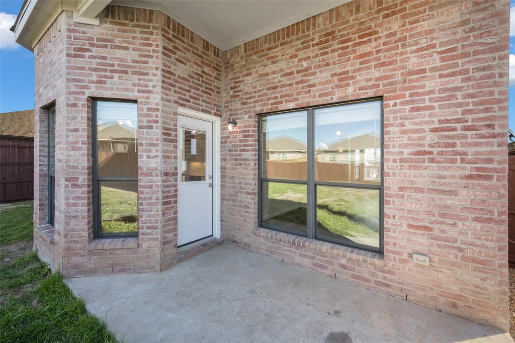 826 Hazel's Way Anna, TX 75409 - Photo 23 of 25 a view of a brick house with a large window