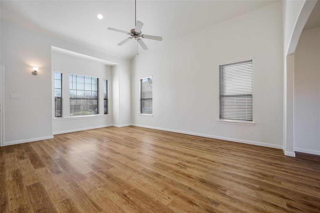 826 Hazel's Way Anna, TX 75409 - Photo 6 of 25 a view of an empty room with wooden floor and a window