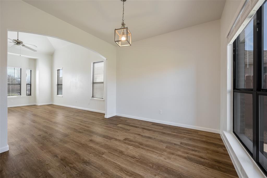 826 Hazel's Way Anna, TX 75409 - Photo 8 of 25 a view of an empty room with wooden floor and a window