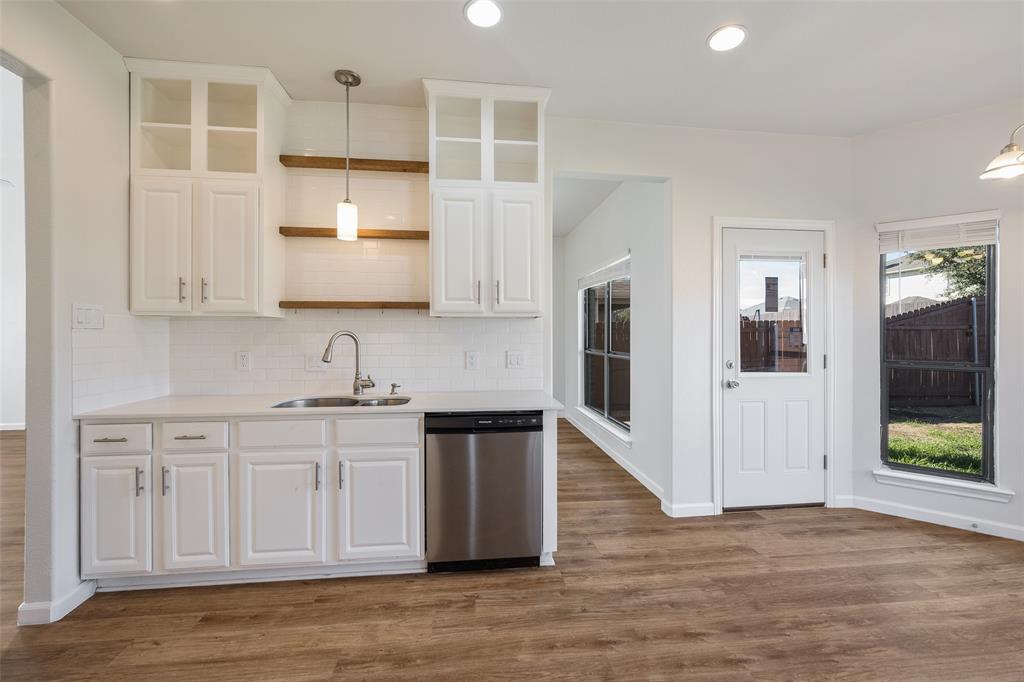 826 Hazel's Way Anna, TX 75409 - Photo 9 of 25 a kitchen with stainless steel appliances granite countertop a refrigerator sink and cabinets