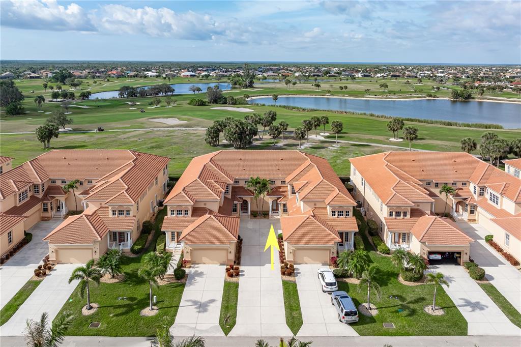 an aerial view of a house with a yard and lake view