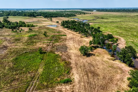 an aerial view of a house with a yard and lake view