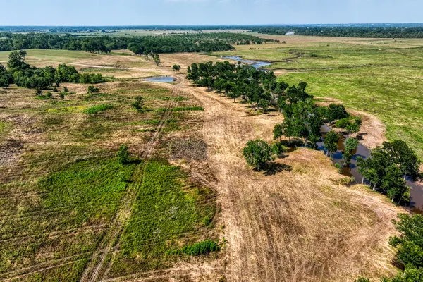 an aerial view of a house with a yard and lake view