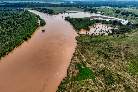 a view of a field with an ocean view