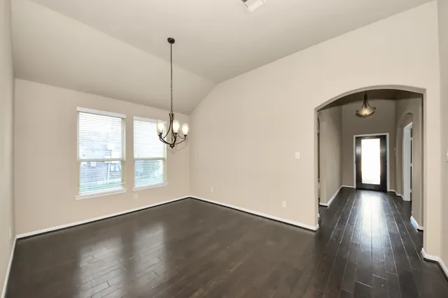a view of a room with wooden floor and windows