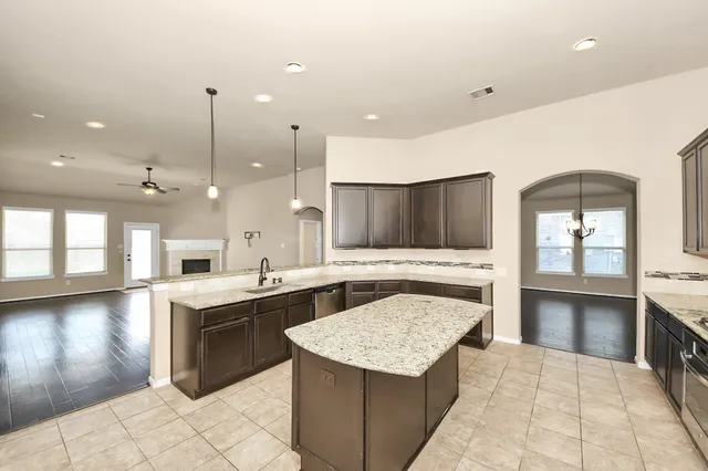 a kitchen with a stove a sink and a refrigerator