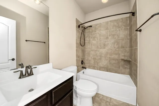 a bathroom with a sink mirror toilet and bathtub