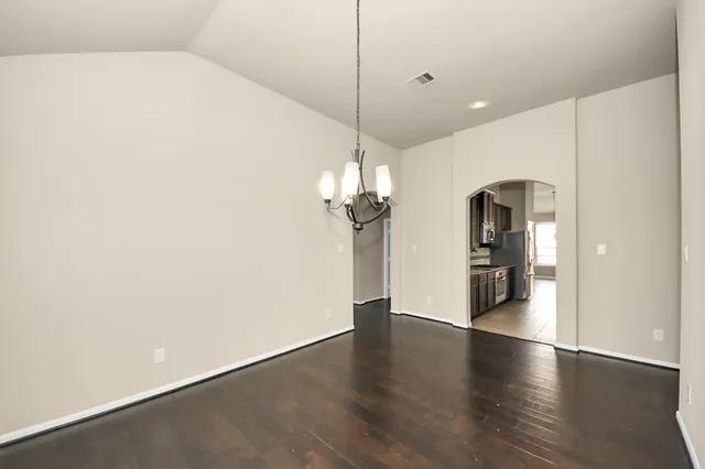 a view of a room with wooden floor