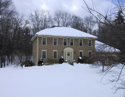 16 Crockett Road Upton, MA 01757 - Photo 1 of 3 a front view of a house with a yard covered in snow