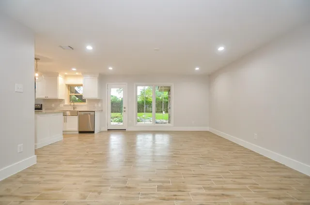 a view of a kitchen with a sink and a window