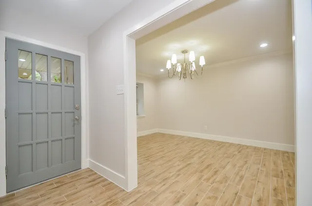 wooden floor in an empty room with a mirror