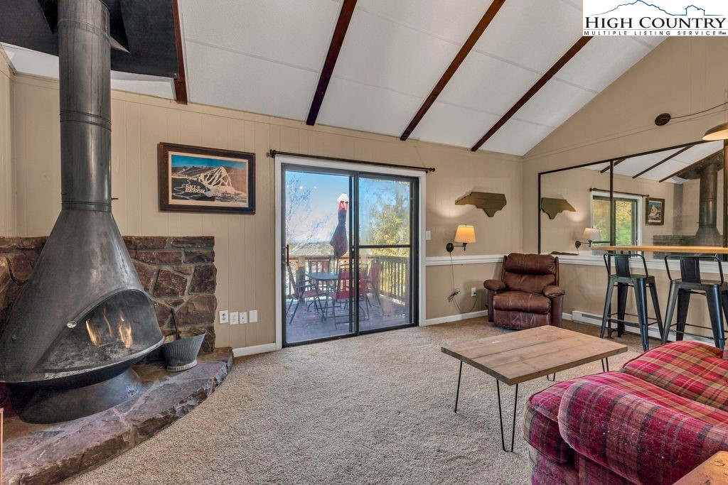 101 Hornbeam Road, Unit 2B Beech Mountain, NC 28604 - Photo 3 of 35 a living room with furniture a flat screen tv and a large window