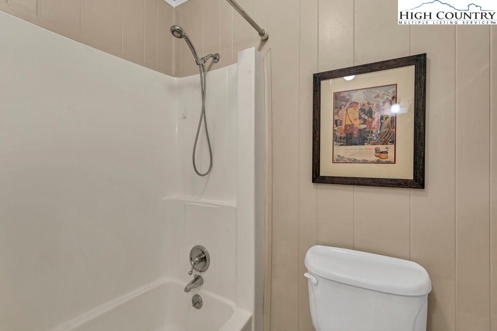 101 Hornbeam Road, Unit 2B Beech Mountain, NC 28604 - Photo 7 of 35 a white toilet sitting next to a bath tub and a shower