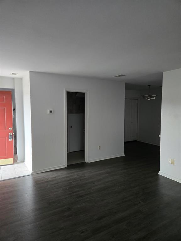 1111 Bert Drive, Unit C Arlington, TX 76012 - Photo 8 of 11 a view of an empty room with wooden floor and closet