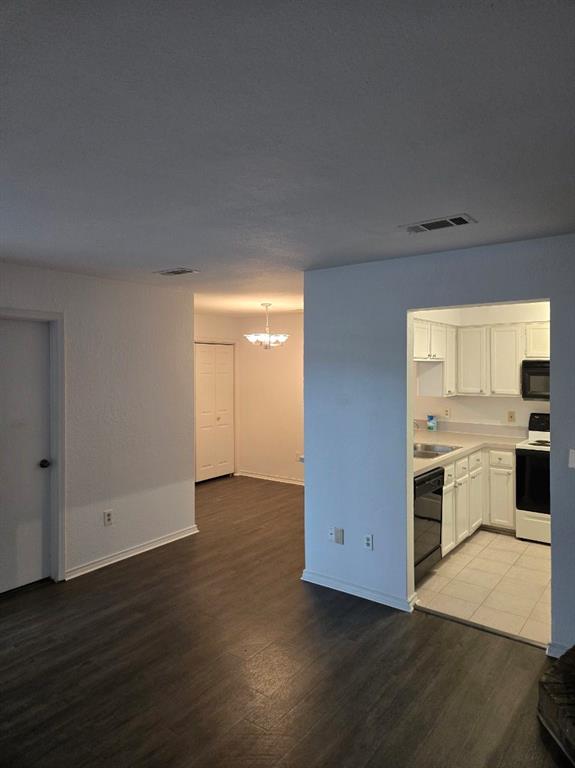 1111 Bert Drive, Unit C Arlington, TX 76012 - Photo 9 of 11 a view of a kitchen with wooden floor and a sink