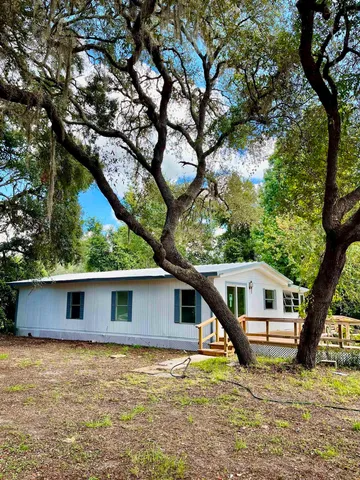 a house view with a backyard space