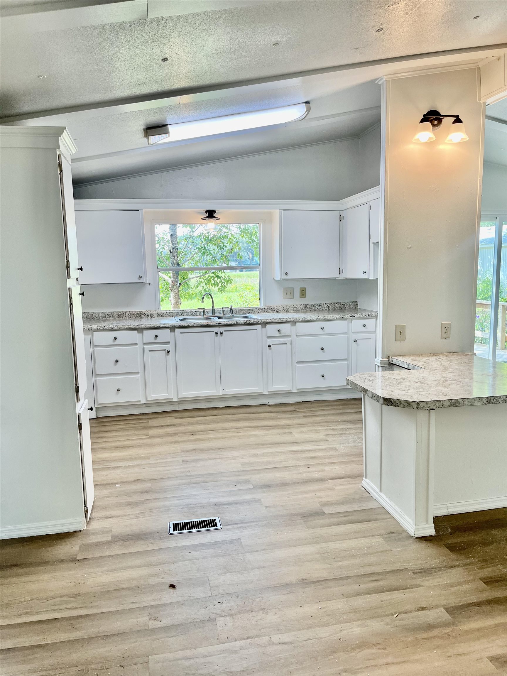 23670 Northeast 154th Place Road Salt Springs, FL 32134 - Photo 14 of 65 a view of kitchen with wooden floor and window