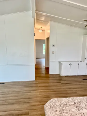 a view of a room with a window and a ceiling fan