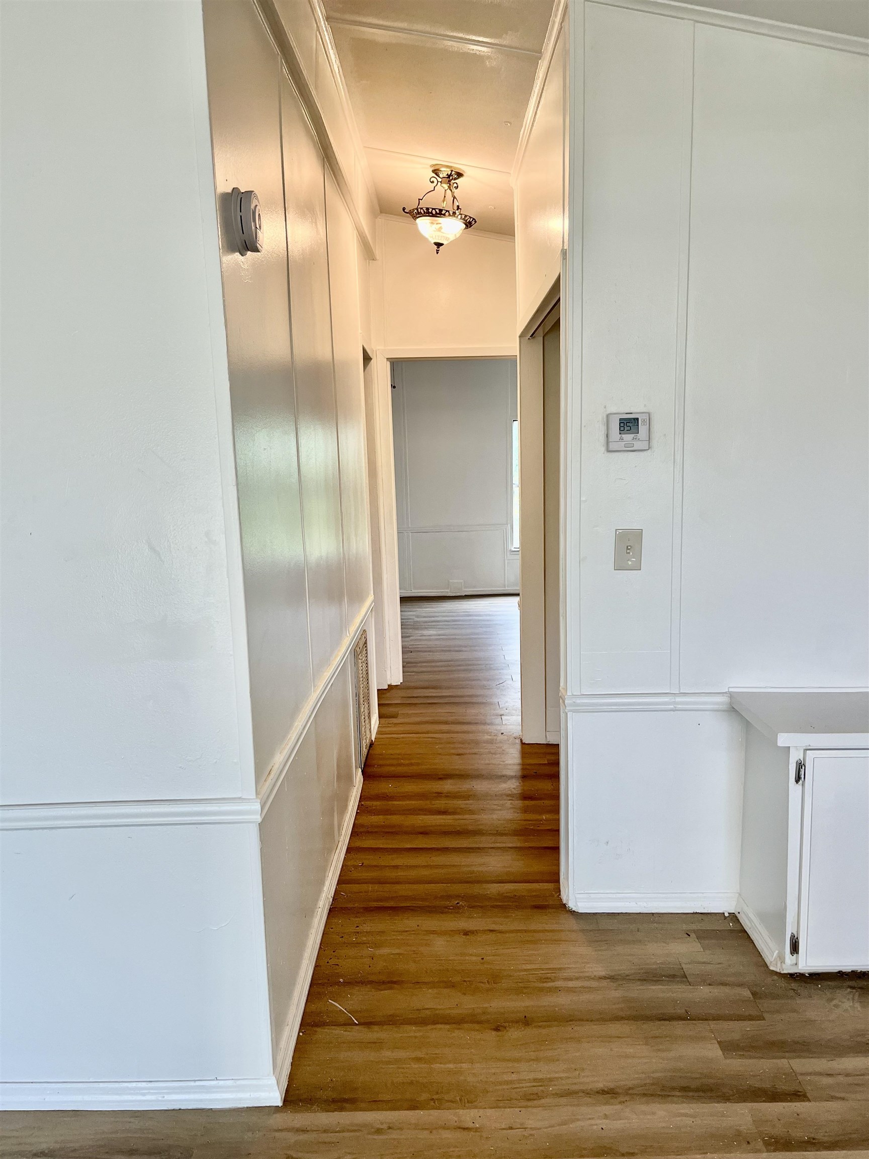 23670 Northeast 154th Place Road Salt Springs, FL 32134 - Photo 16 of 65 a view of a hallway with wooden floor