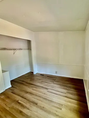 a view of a room with wooden floor