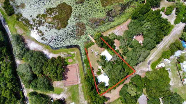 an aerial view of a residential houses with yard