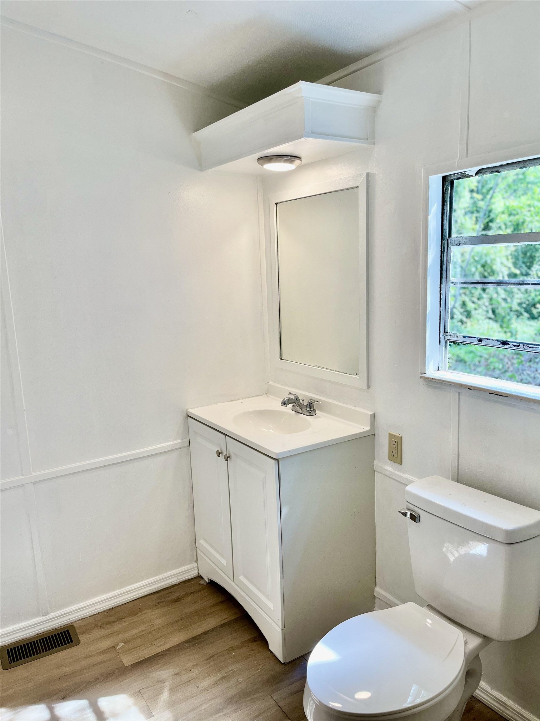 23670 Northeast 154th Place Road Salt Springs, FL 32134 - Photo 21 of 65 a bathroom with a sink mirror vanity and toilet