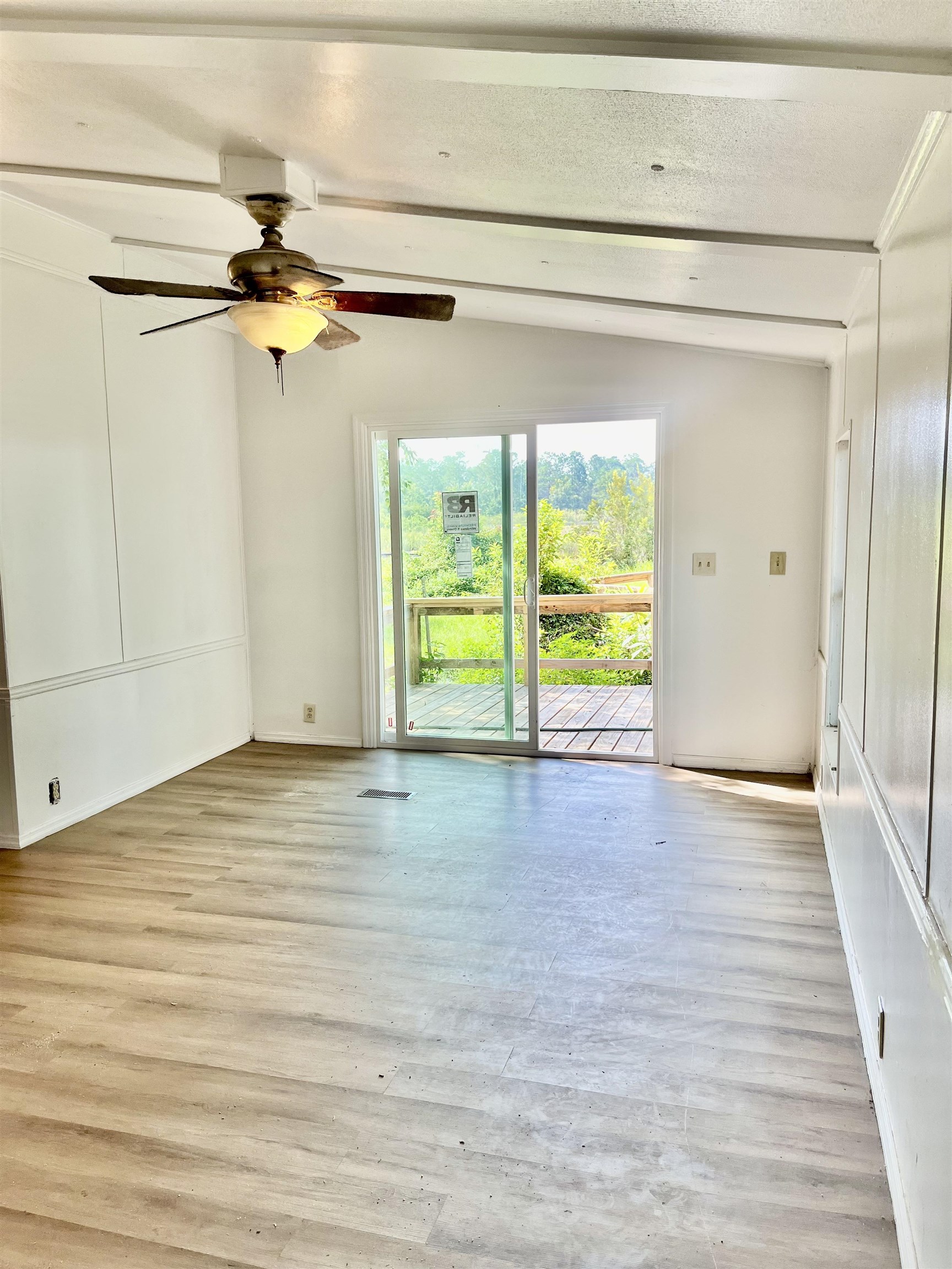 23670 Northeast 154th Place Road Salt Springs, FL 32134 - Photo 6 of 65 a view of a room with wooden floor and a window