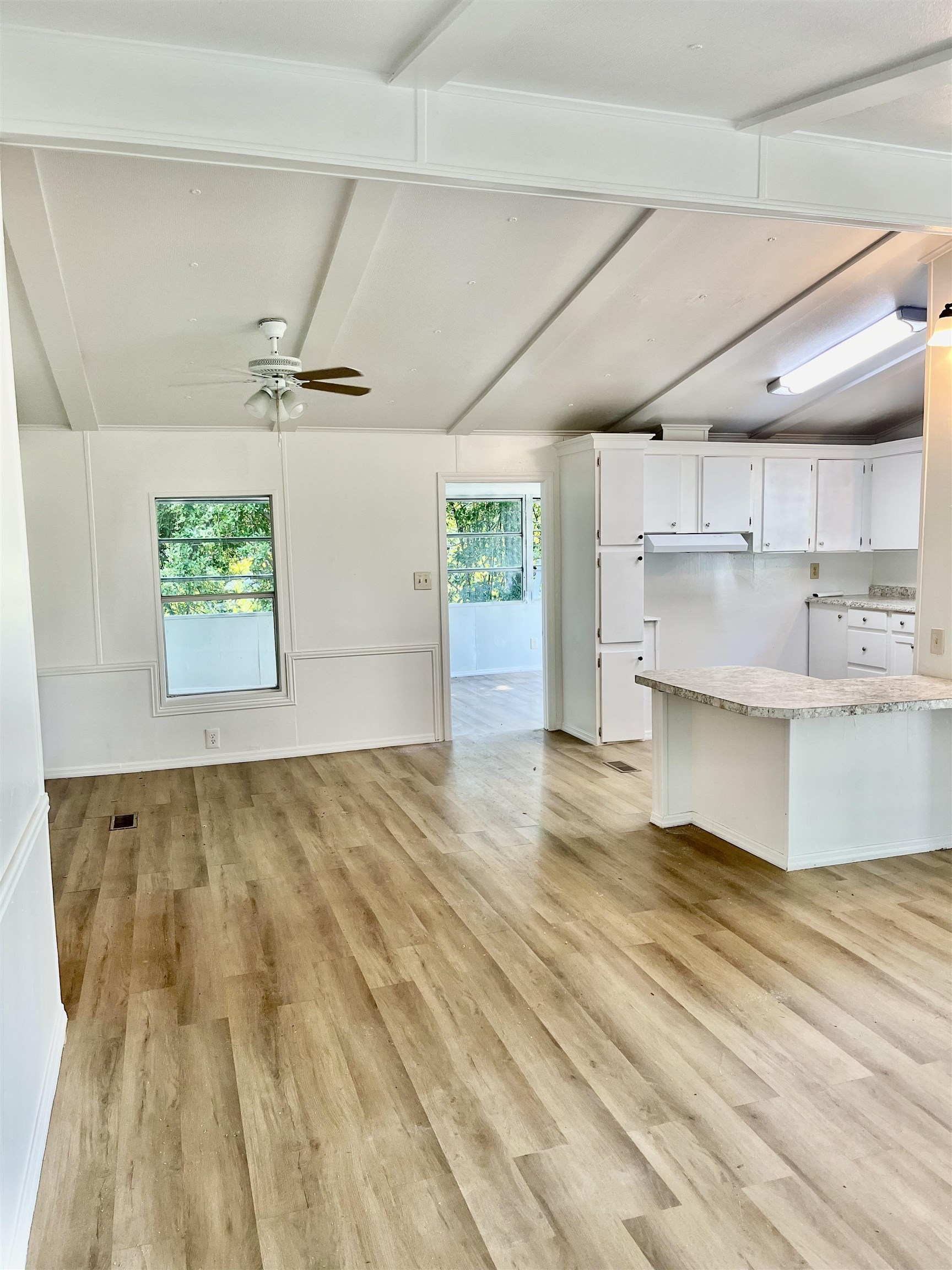 23670 Northeast 154th Place Road Salt Springs, FL 32134 - Photo 8 of 65 a view of kitchen and empty room with wooden floor