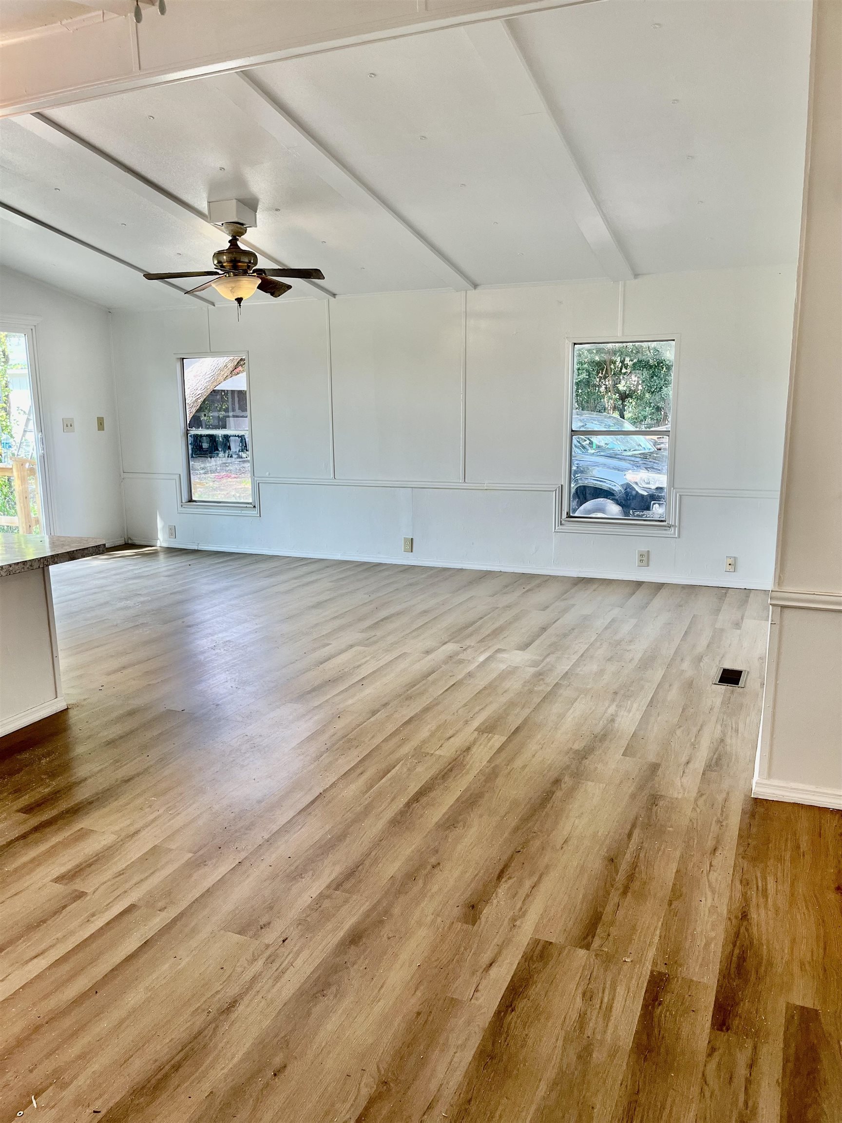 23670 Northeast 154th Place Road Salt Springs, FL 32134 - Photo 9 of 65 an empty room with wooden floor and windows