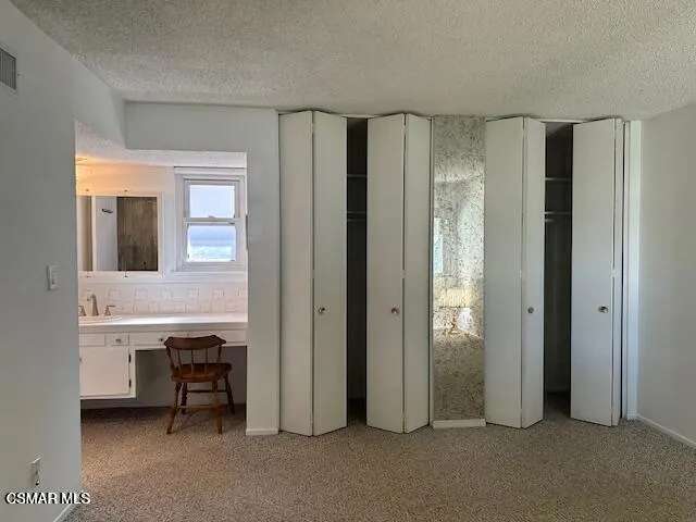 a view of a bathroom with a sink and a mirror