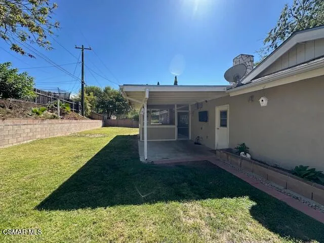 a view of a house with backyard and porch