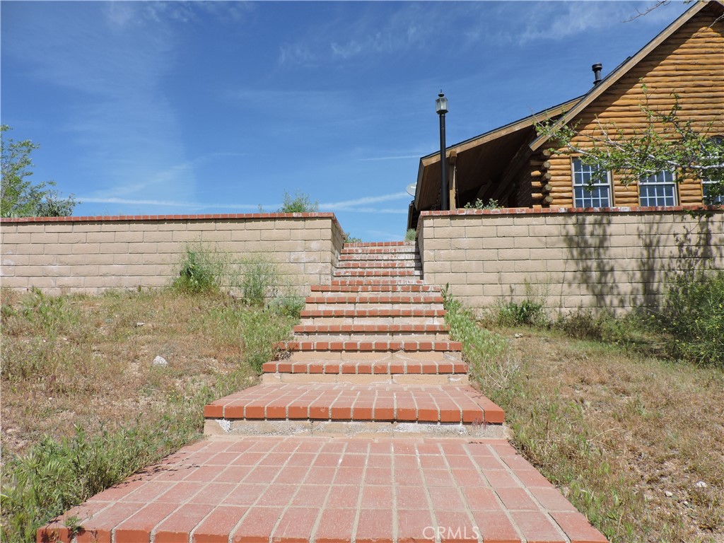5480 Sunnyslope Road Phelan, CA 92371 - Photo 14 of 47 a view of a yard with an outdoor space