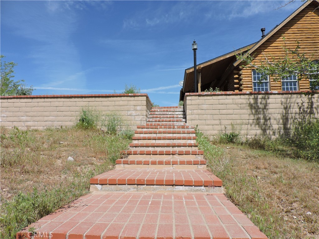 5480 Sunnyslope Road Phelan, CA 92371 - Photo 16 of 47 a view of a yard with an outdoor space