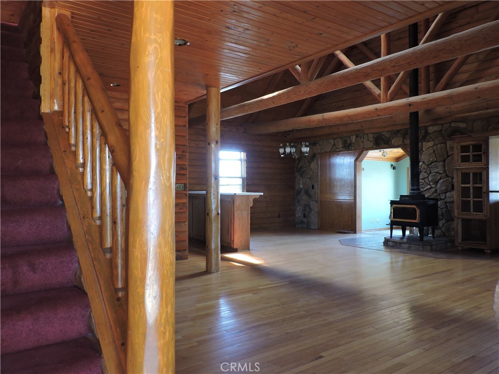 5480 Sunnyslope Road Phelan, CA 92371 - Photo 30 of 47 a view of a hallway with wooden floor and a fireplace