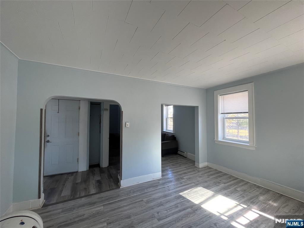 129 Orient Way, Unit 2 Lyndhurst, NJ 07071 - Photo 16 of 29 an empty room with wooden floor and windows