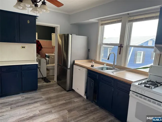 a kitchen with stainless steel appliances granite countertop a refrigerator and a stove
