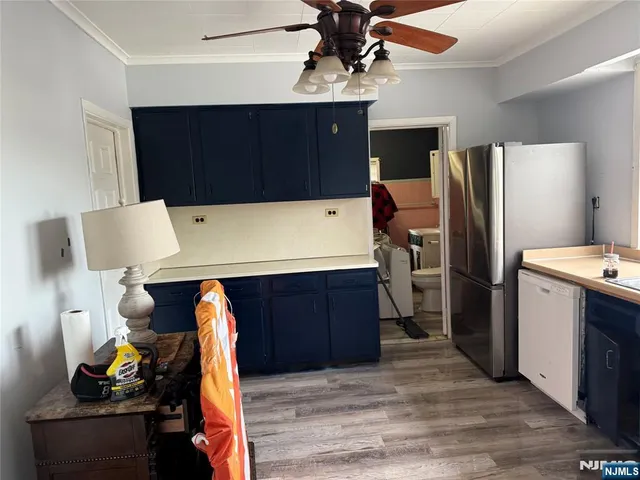 a kitchen with stainless steel appliances a stove refrigerator and cabinets