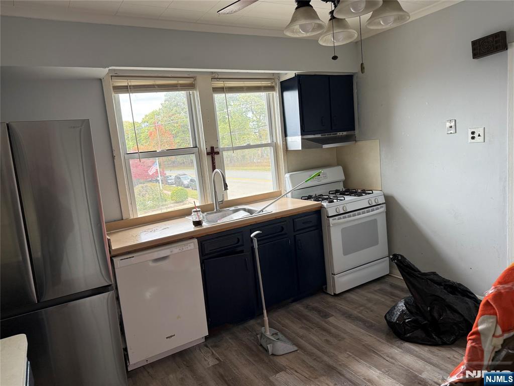 129 Orient Way, Unit 2 Lyndhurst, NJ 07071 - Photo 5 of 29 a kitchen with a sink wooden floor and a window